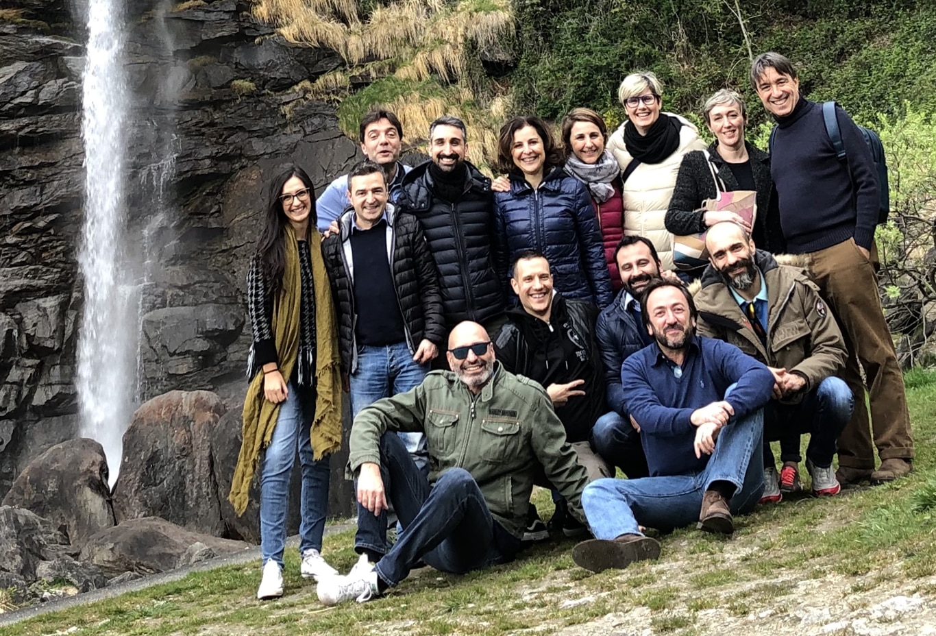 Group posing for a photo in front of a small waterfall in Milan, Italy