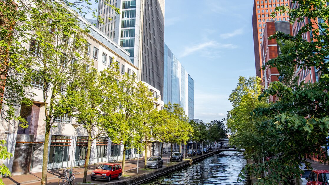 Skyscrapers on either side of the water channel in Haag city, Netherlands